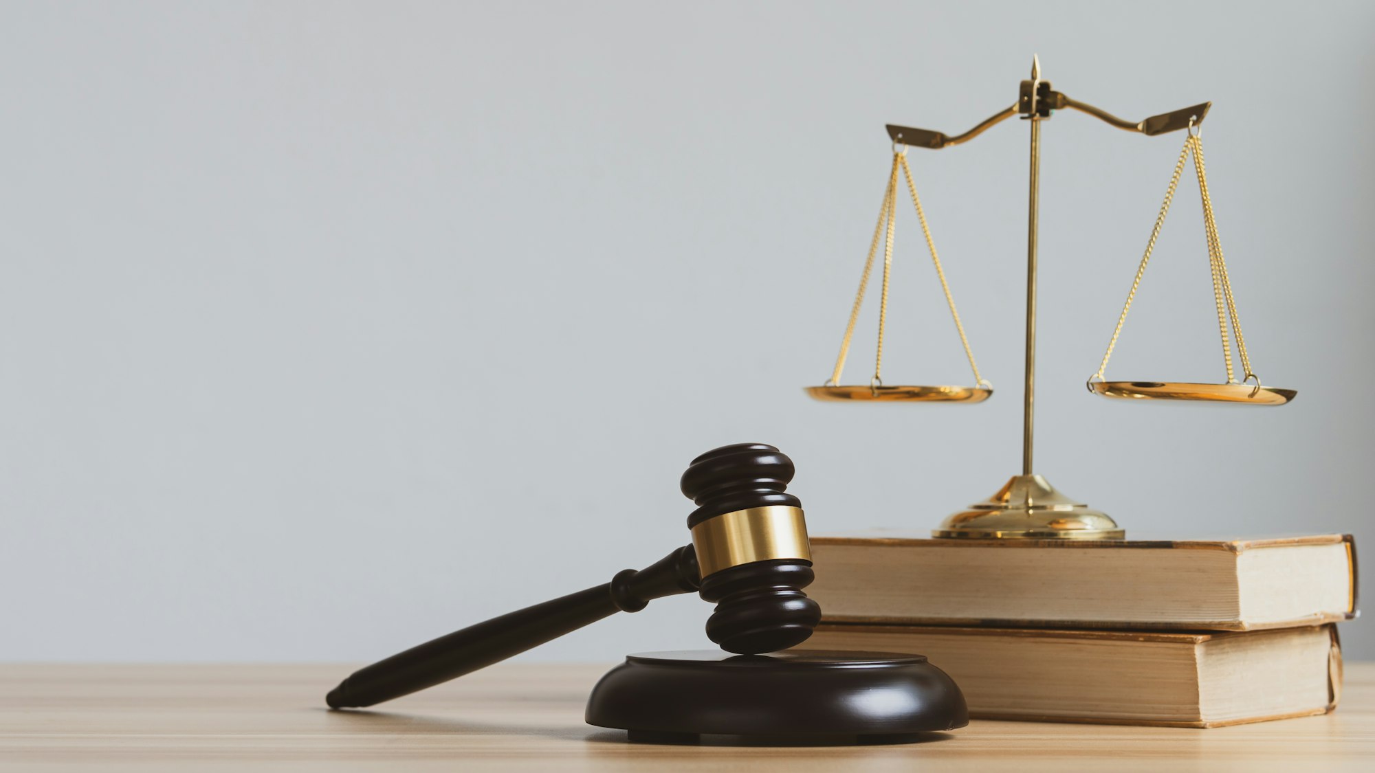 Law and justice concept. Mallet of the judge, scales and stack books with copyspace.